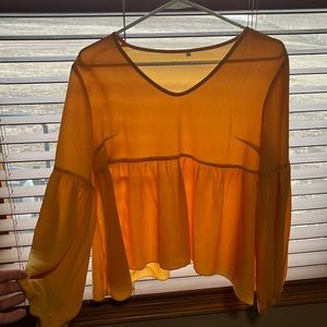 Yellow, partly see through, bell-sleeved shirt. Wore once for senior pictures.